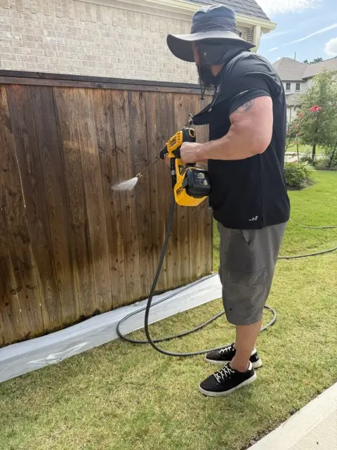 WOLF technician treating fence surface