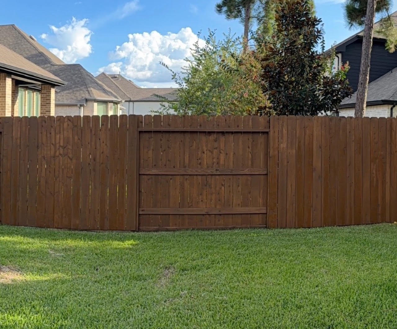 Woodforest fence after restoration and staining